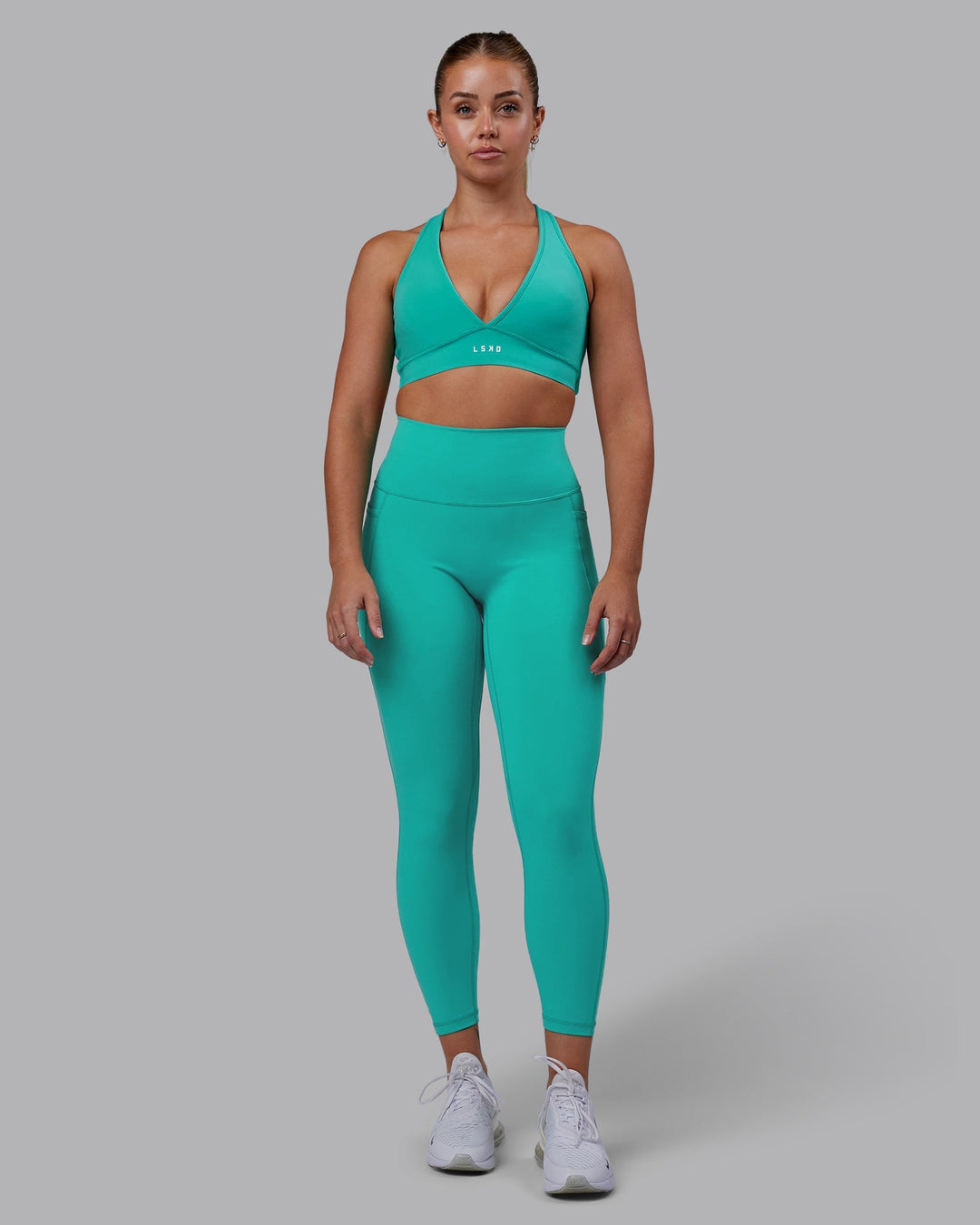 Woman wearing Stamina Sports Bra - Turquoise Tide