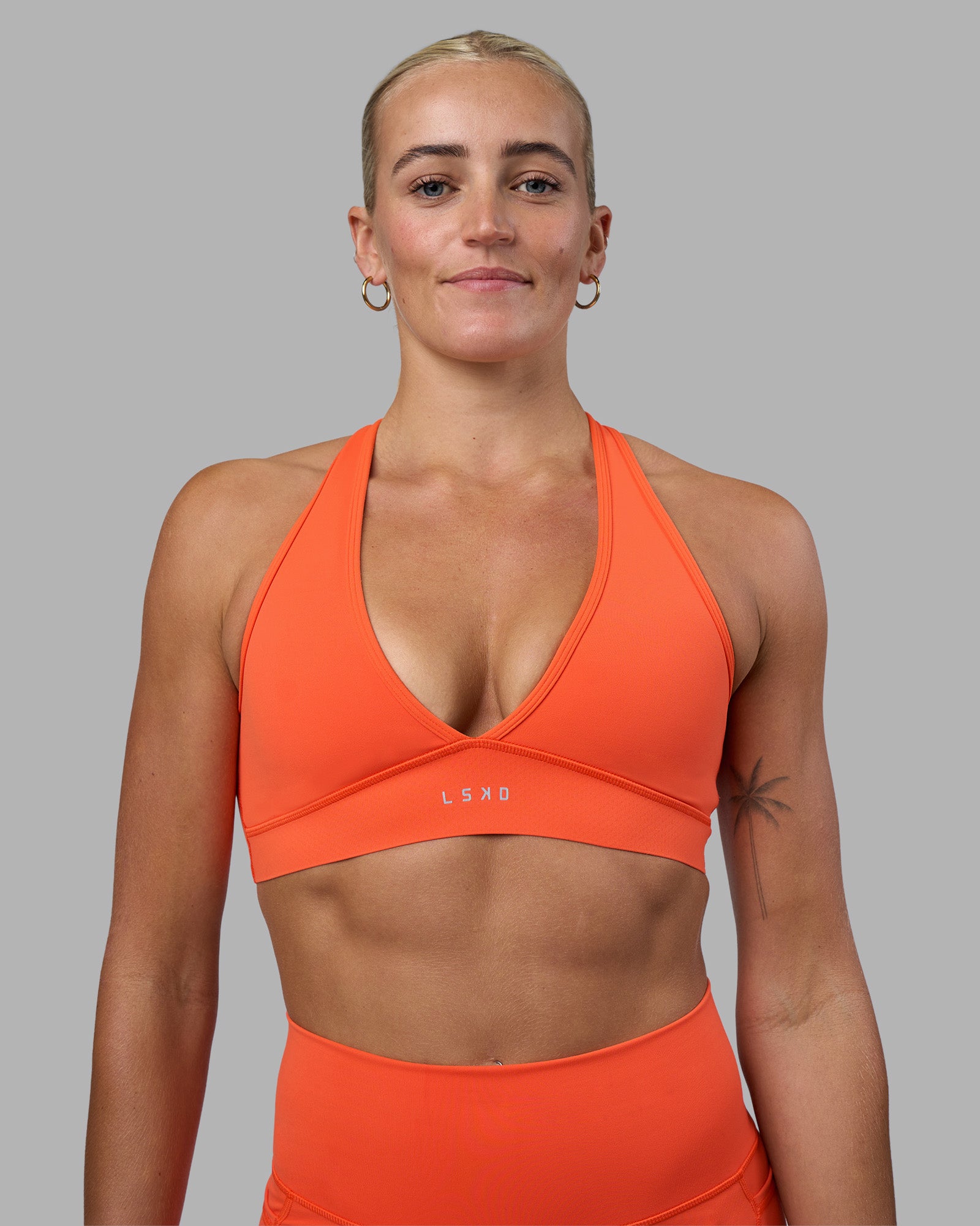 Woman wearing Stamina Sports Bra - Ultra Orange | Model:Katie | Size:S