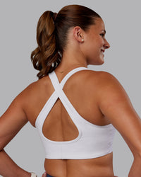 Woman wearing Stamina Sports Bra - White | Set:true | Angle:back | Model:Phoebe | Size:S