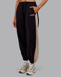 Woman wearing Stitch Up Fleece Sweat Pant - Black/Shale Beige | Model:Ella | Size:S