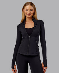 Woman wearing Stride Thermal Zip Through Jacket - Black | Model:Ella | Size:S