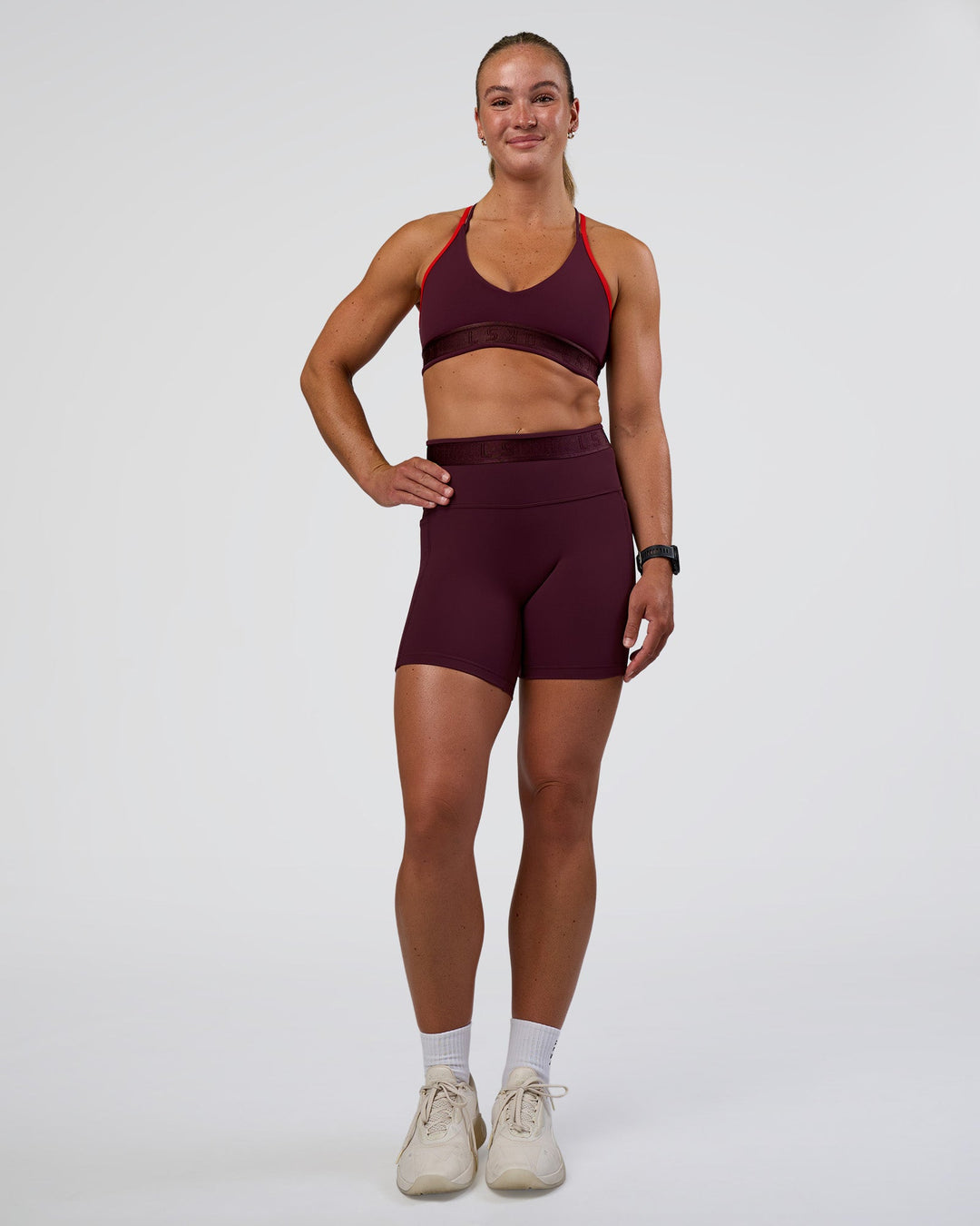 Woman wearing Strive Jacquard Sports Bra - Cherry Lacquer | Model:Sav | Size:S