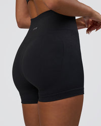 Woman wearing Surge Seamless High-Rise 4" Short - Black | Model:Bianca | Size:S