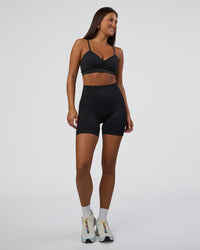 Woman wearing Surge Seamless High-Rise 6" Short - Black | Model:Bianca | Size:S