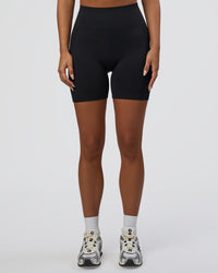 Woman wearing Surge Seamless High-Rise 6" Short - Black | Model:Bianca | Size:S