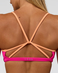 Woman wearing Tempo Sports Bra - Ultra Pink-Cantaloupe | Model:Amity | Size:S