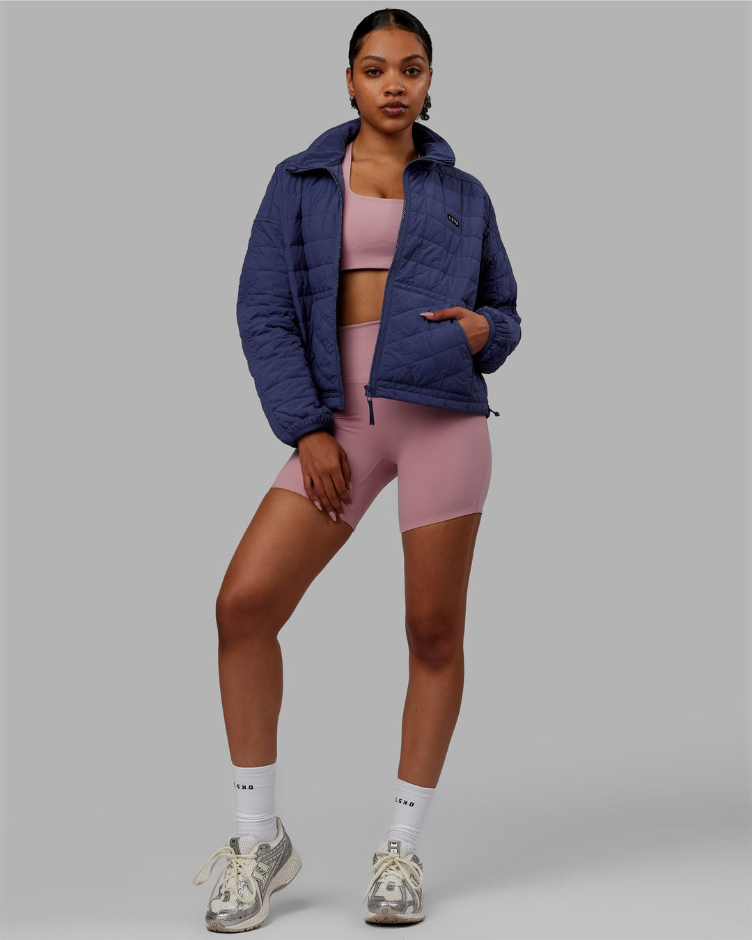 Woman wearing Thrive Packable Jacket - Future Dusk