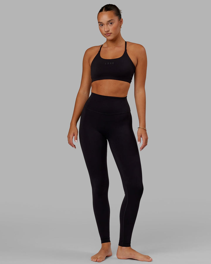 Woman wearing Twist Sports Bra - Black
