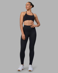 Woman wearing Twist Sports Bra - Black | Model:Sophie | Size:S