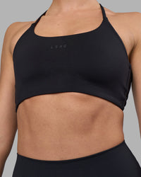 Woman wearing Twist Sports Bra - Black | Model:Sophie | Size:S