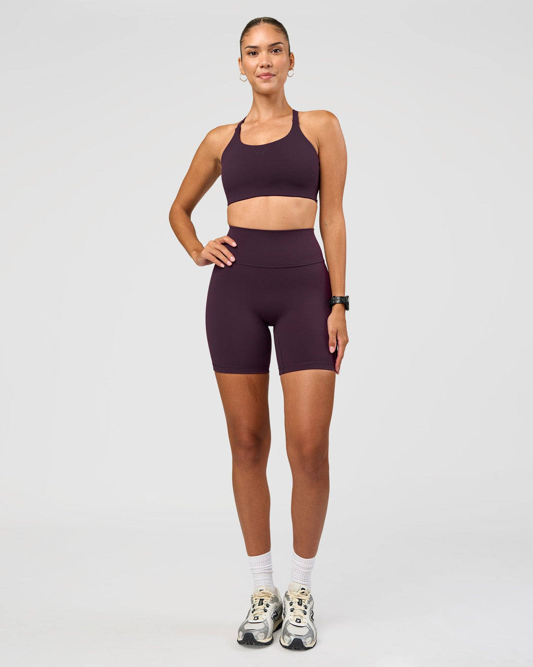 Woman wearing Twist Sports Bra D/DD/E - Midnight Plum | Model:Rhiley | Size:S