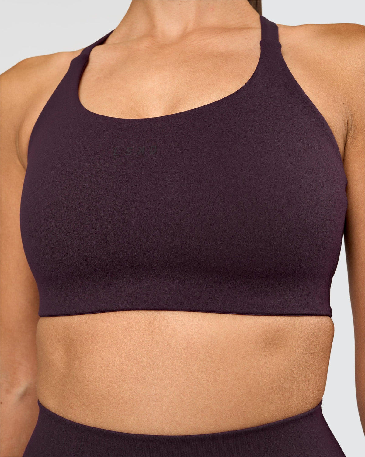 Woman wearing Twist Sports Bra D/DD/E - Midnight Plum | Model:Rhiley | Size:S - view 1