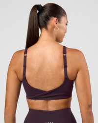 Woman wearing Twist Sports Bra D/DD/E - Midnight Plum | Model:Rhiley | Size:S