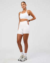 Woman wearing Twist Sports Bra D/DD/E - White | Model:Rhiley | Size:S