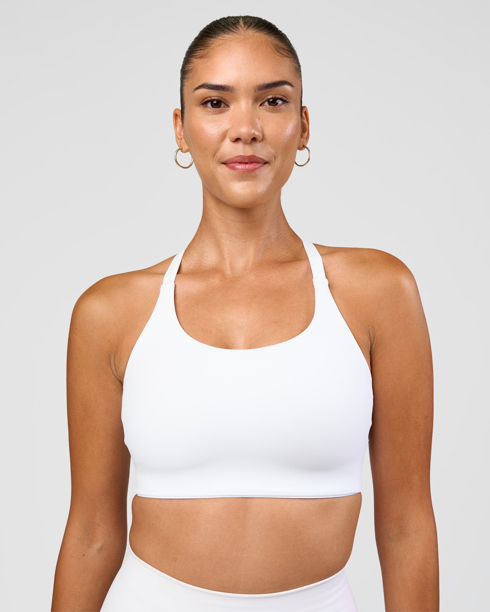 Woman wearing Twist Sports Bra D/DD/E - White | Model:Rhiley | Size:S