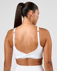 Woman wearing Twist Sports Bra D/DD/E - White | Model:Rhiley | Size:S