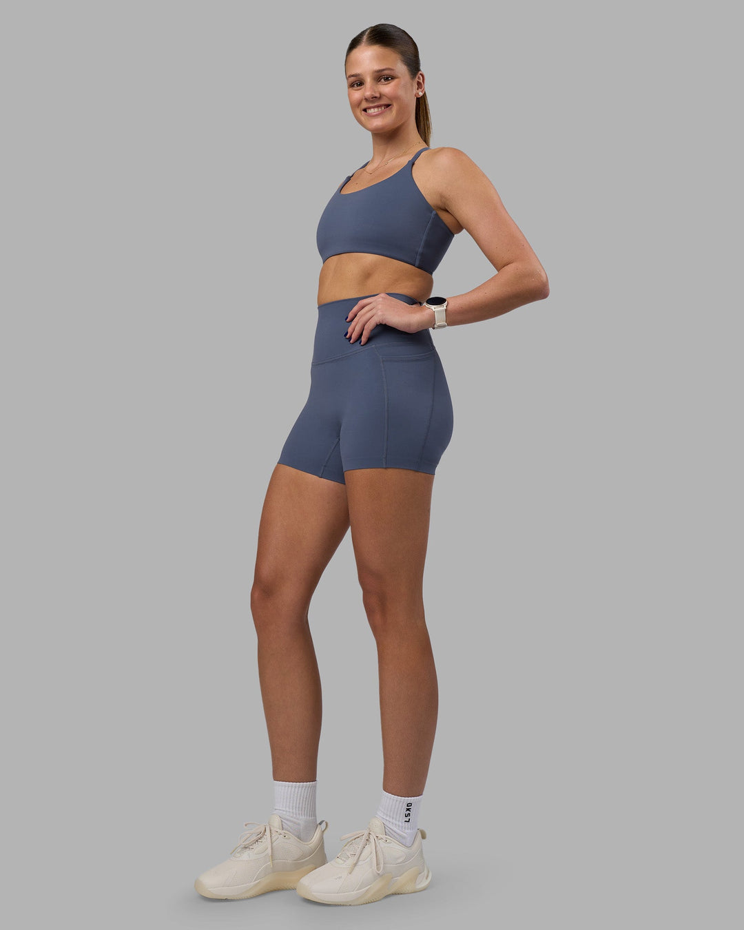 Woman wearing Twist Sports Bra - Night Shadow | Model:Phoebe | Size:S