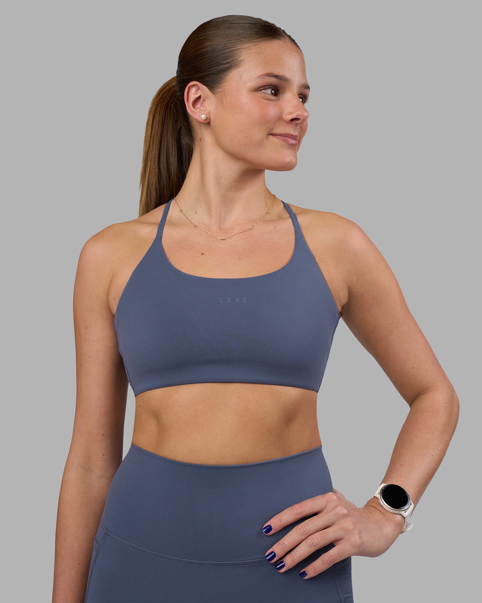Woman wearing Twist Sports Bra - Night Shadow | Model:Phoebe | Size:S