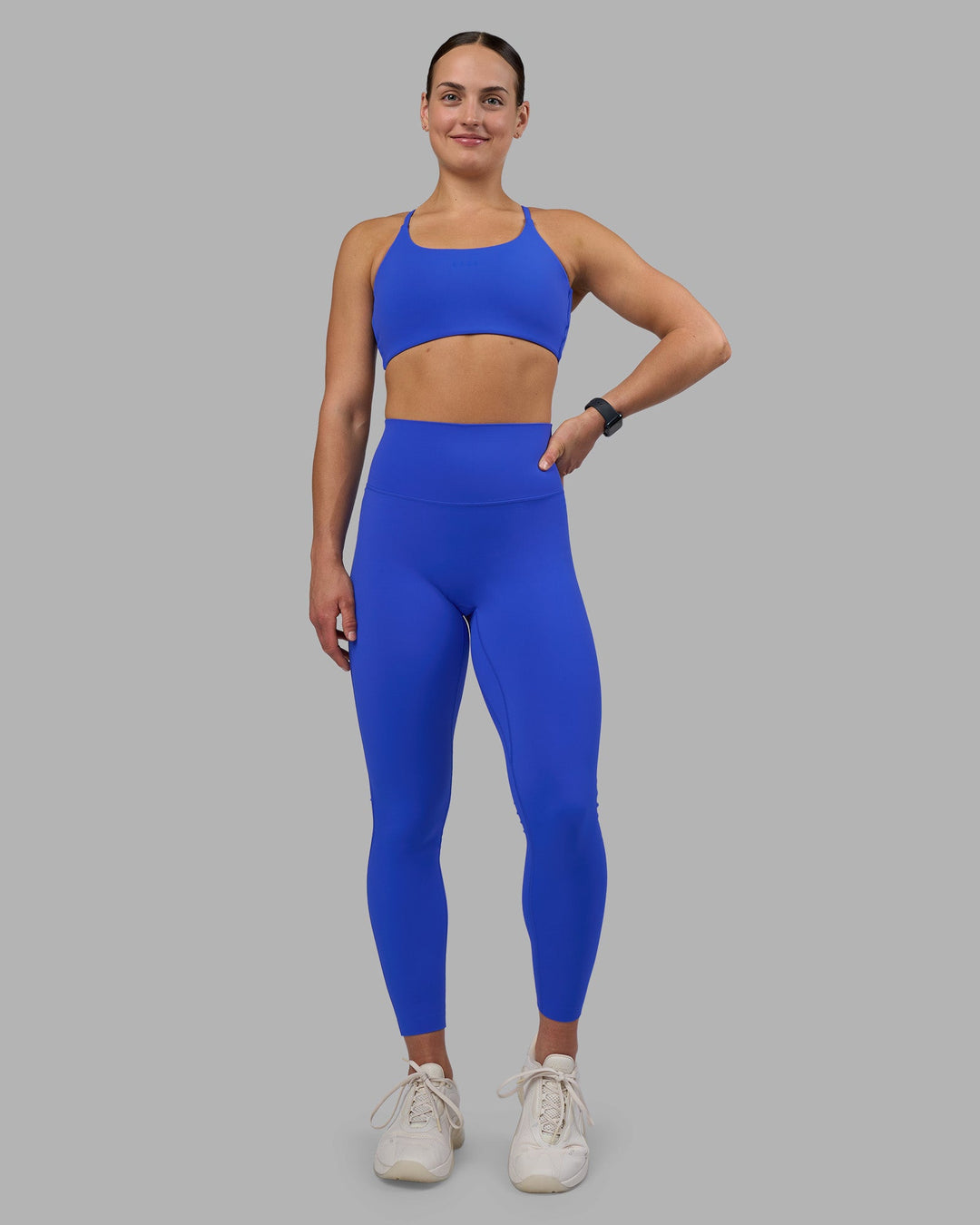 Woman wearing Twist Sports Bra - Power Cobalt | Model:Keisha | Size:S