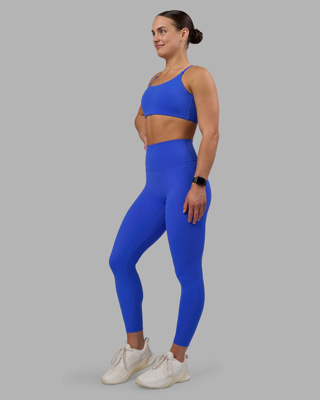 Woman wearing Twist Sports Bra - Power Cobalt | Model:Keisha | Size:S