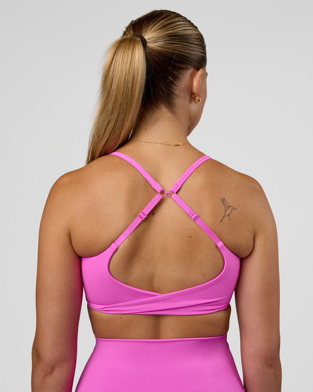 Woman wearing Twist Sports Bra - Ultra Fuchsia | Model:Myrte | Size:S - view 2
