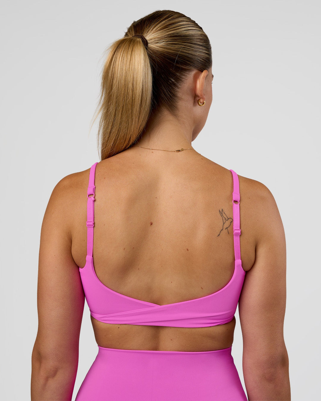 Woman wearing Twist Sports Bra - Ultra Fuchsia | Model:Myrte | Size:S - view 5