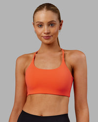 Woman wearing Twist Sports Bra - Ultra Orange | Model:Ella | Size:S