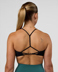 Woman wearing Twister Sports Bra - Black  | Model:Myrte | Size:S
