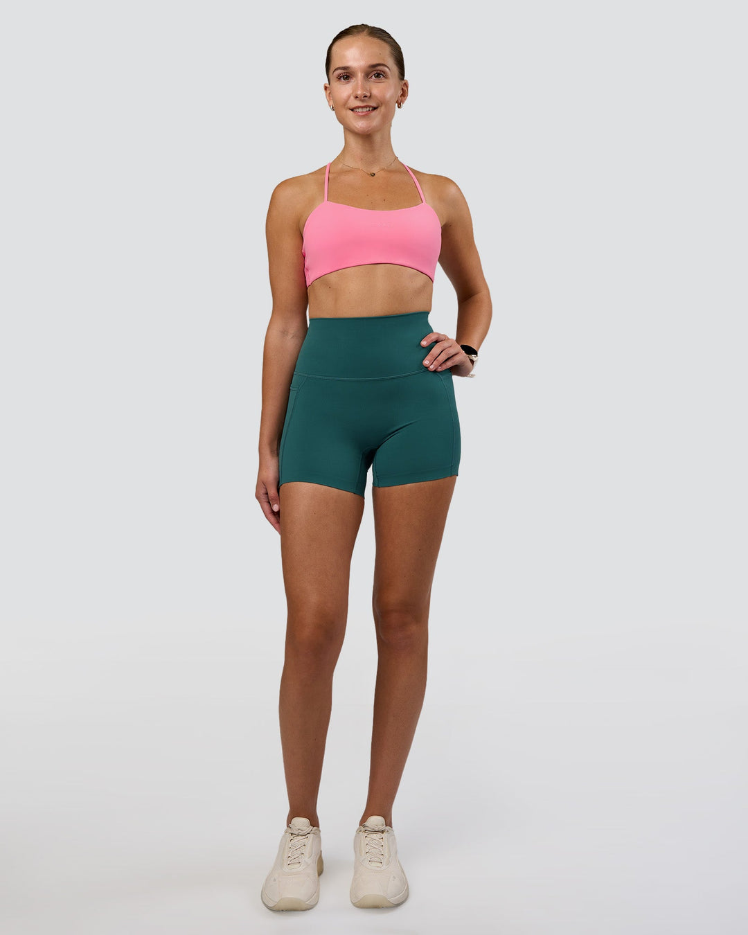 Woman wearing Twister Sports Bra - Candy Pink | Model:Myrte | Size:S