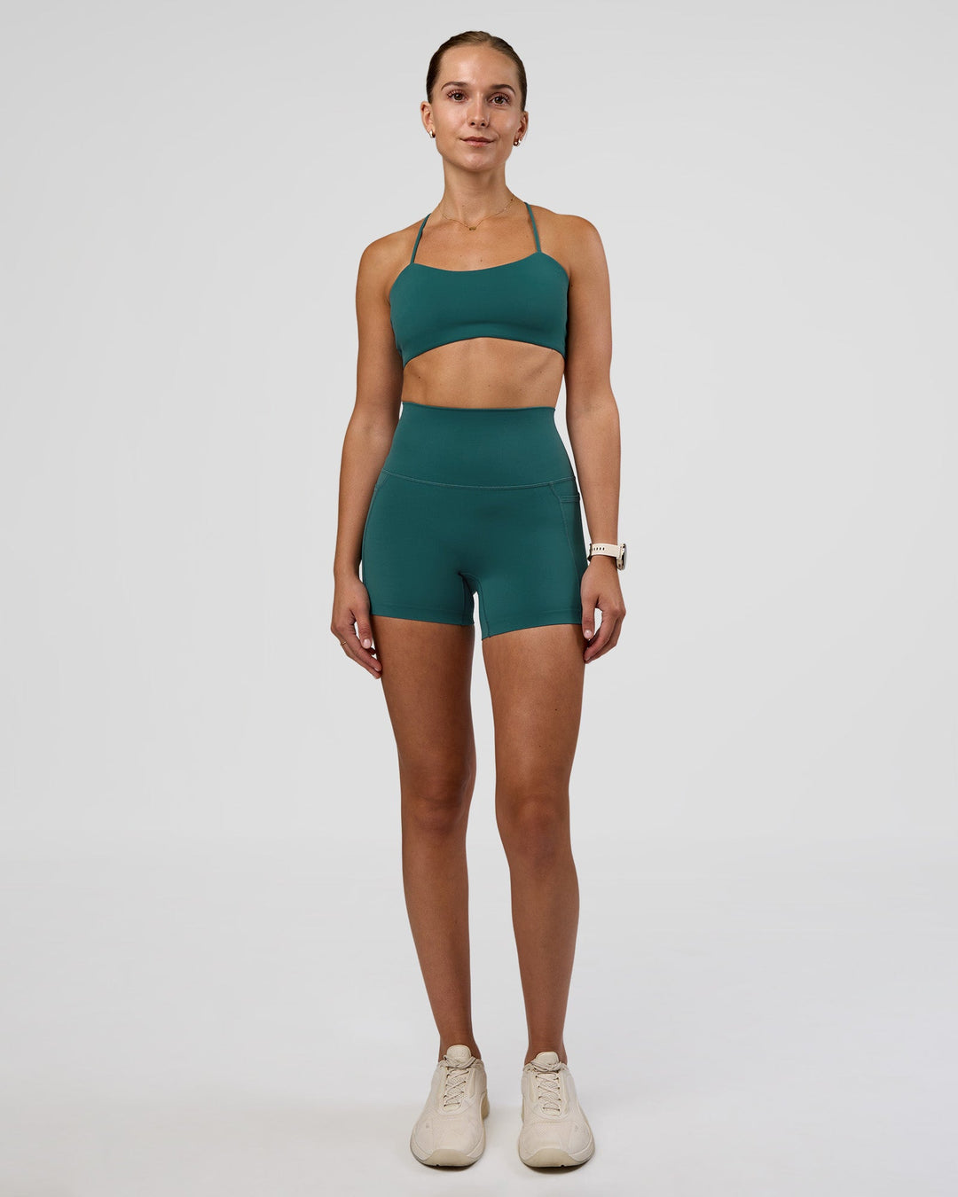 Woman wearing Twister Sports Bra - Transformative Teal | Model:Myrte | Size:S