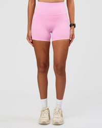 Woman wearing Unbreakable Ultra High-Rise 4" Short - Pink Rose-White | Model:Rhiley | Size:S