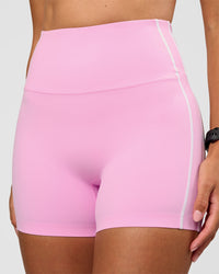 Woman wearing Unbreakable Ultra High-Rise 4" Short - Pink Rose-White | Model:Rhiley | Size:S