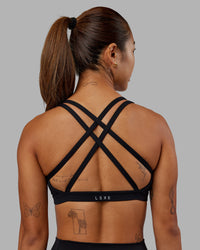 Woman wearing Velocity Sports Bra - Black | Model:Vanessa | Size:S