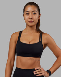 Woman wearing Velocity Sports Bra - Black | Model:Vanessa | Size:S