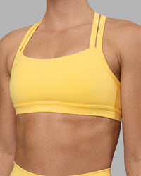 Woman wearing Velocity Sports Bra - Lemon | Model:Charlize | Size:S