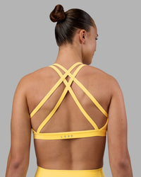 Woman wearing Velocity Sports Bra - Lemon | Model:Charlize | Size:S