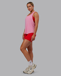 Woman wearing AeroFLX+ Drop Armhole Seamless Tank - Candy Pink | Model:Paris | Size:S
