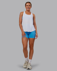 Woman wearing AeroFLX+ Drop Armhole Seamless Tank - White | Model:Paris | Size:S