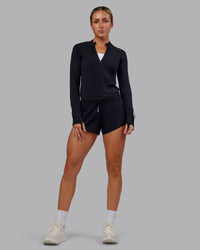 Woman wearing AeroFLX+ Long Sleeve Half Zip - Black Marl | Model:Paris | Size:S