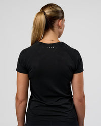 Woman wearing AeroFLX+ Seamless Tee - Black/Black | Model:Myrte | Size:S