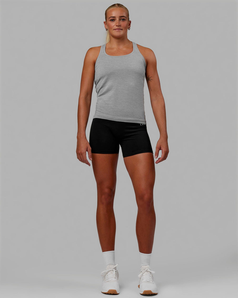 Woman wearing AeroFLX+ Seamless Tank - Light Grey Marl