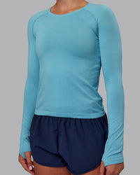 Woman wearing AeroFLX+ Seamless Long Sleeve Tee - Retro Blue/Retro Blue | Model:Charlize | Size:S