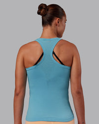 Woman wearing AeroFLX+ Seamless Tank - Retro Blue/Retro Blue | Model:Charlize | Size:S