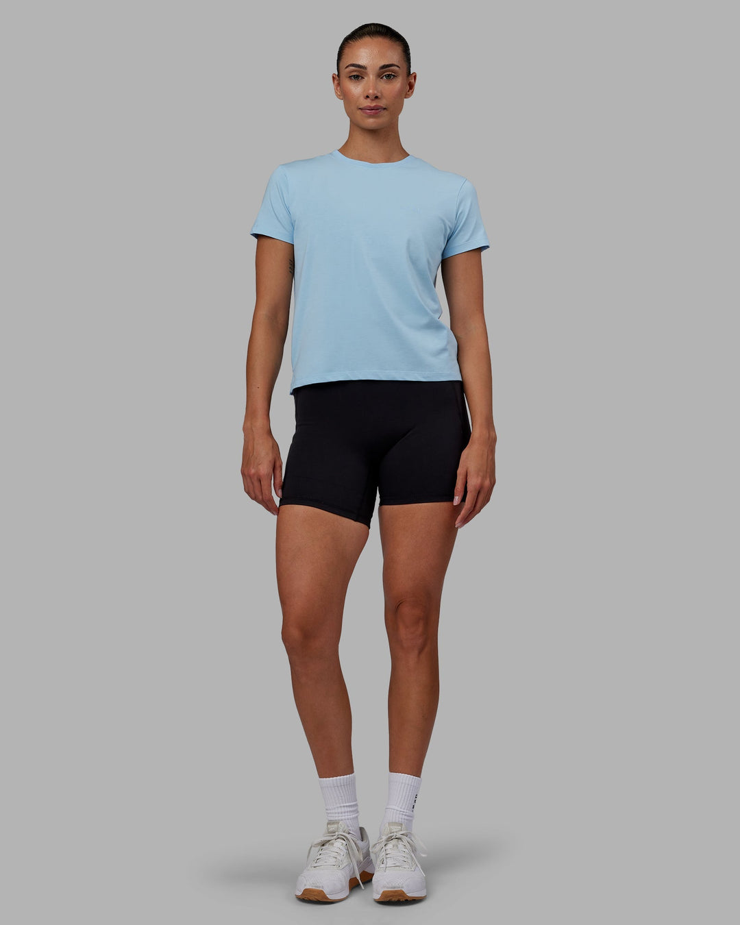 Woman wearing Deluxe PimaFLX Tee - Glacial Blue