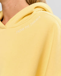 Woman wearing Zola Oversized Hoodie - Lemon | Model:Issy | Size:S