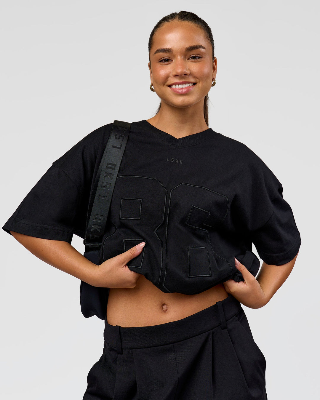 Woman wearing 86 V-Neck Oversized Tee - Black-Black | Model:Sophia | Size:S 