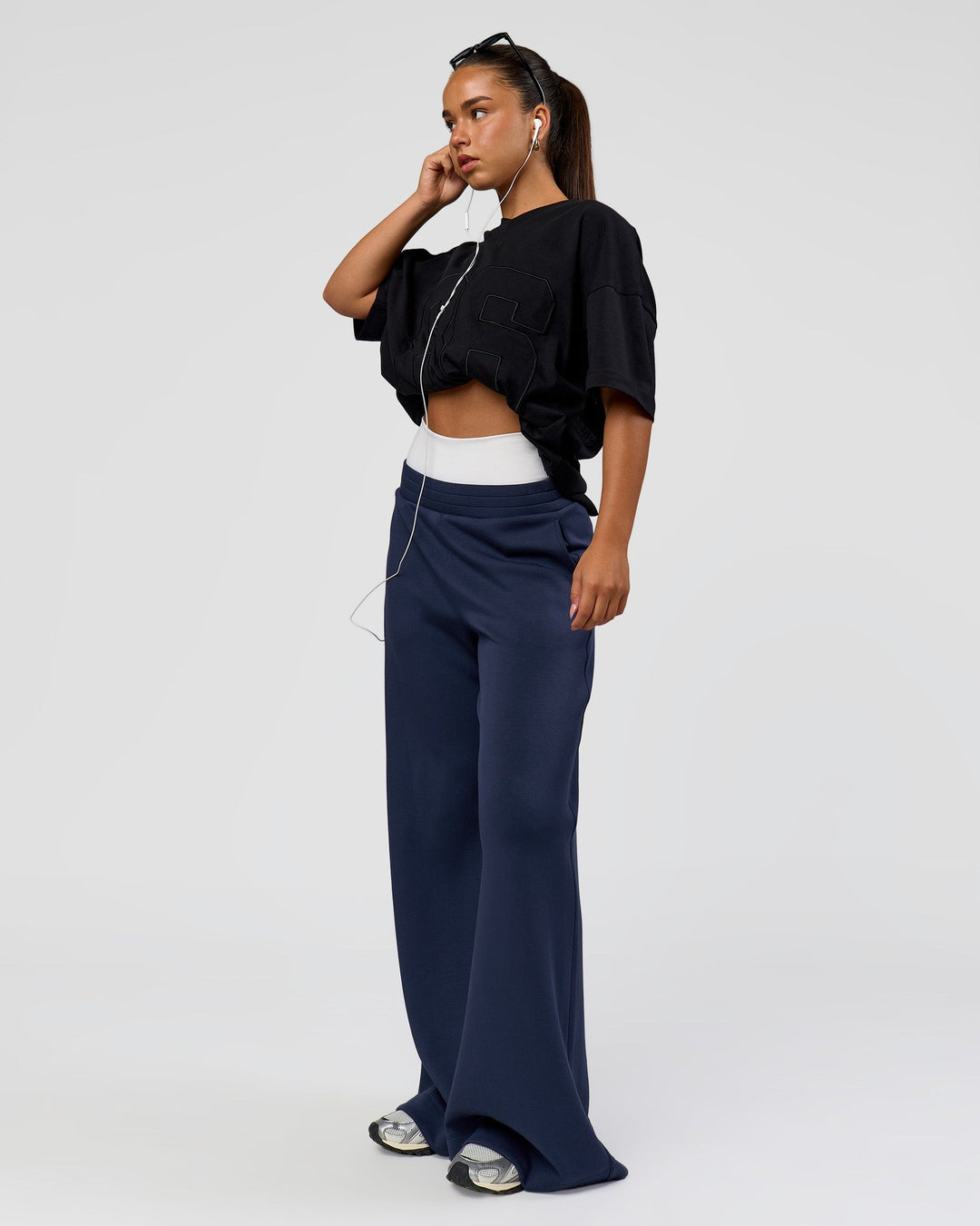 Woman wearing 86 V-Neck Oversized Tee - Black-Black | Model:Sophia | Size:S |