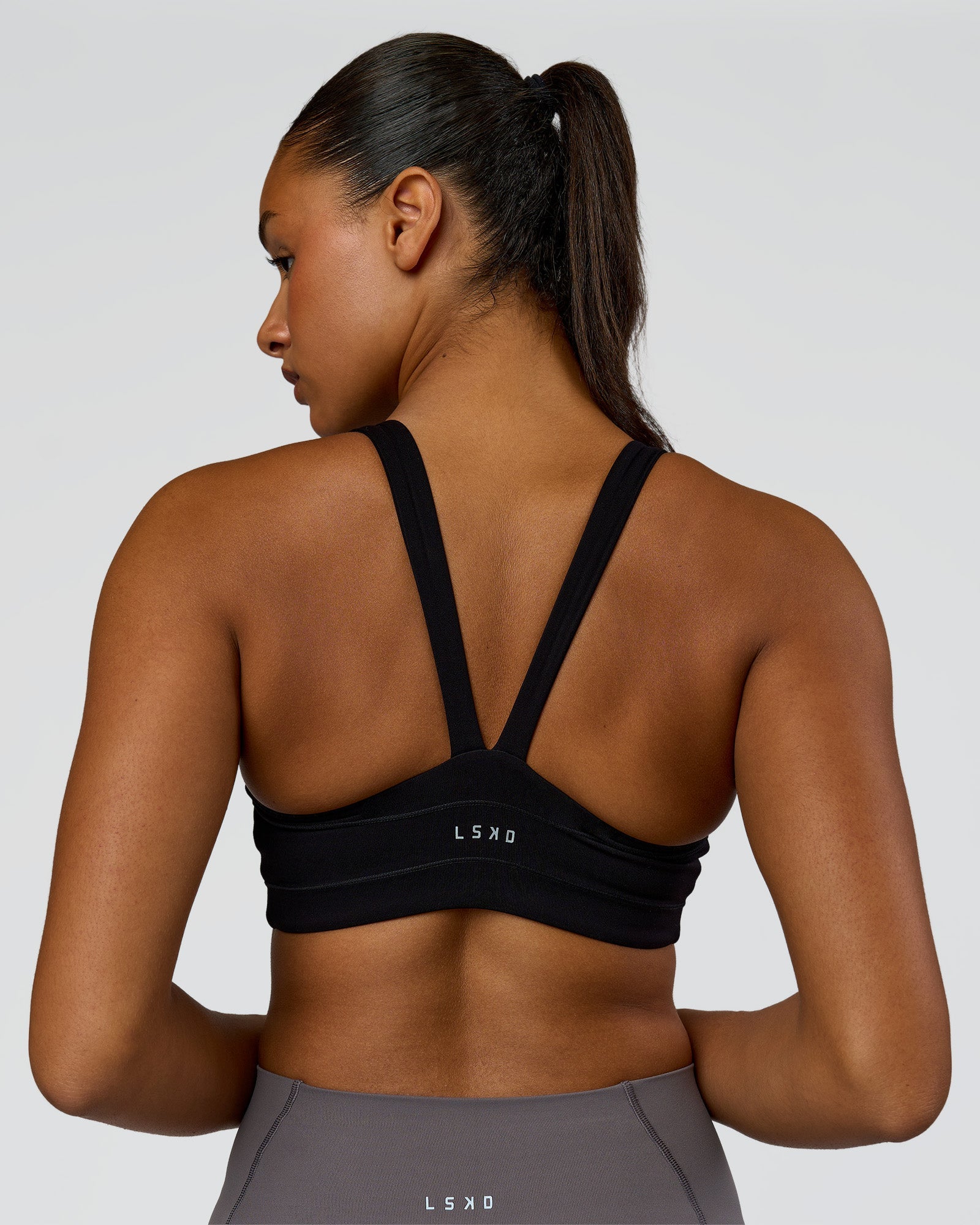 Woman wearing Inertia Sports Bra - Black | Model:Rosie | Size:S