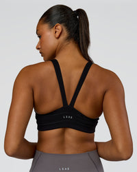 Woman wearing Inertia Sports Bra - Black | Model:Rosie | Size:S