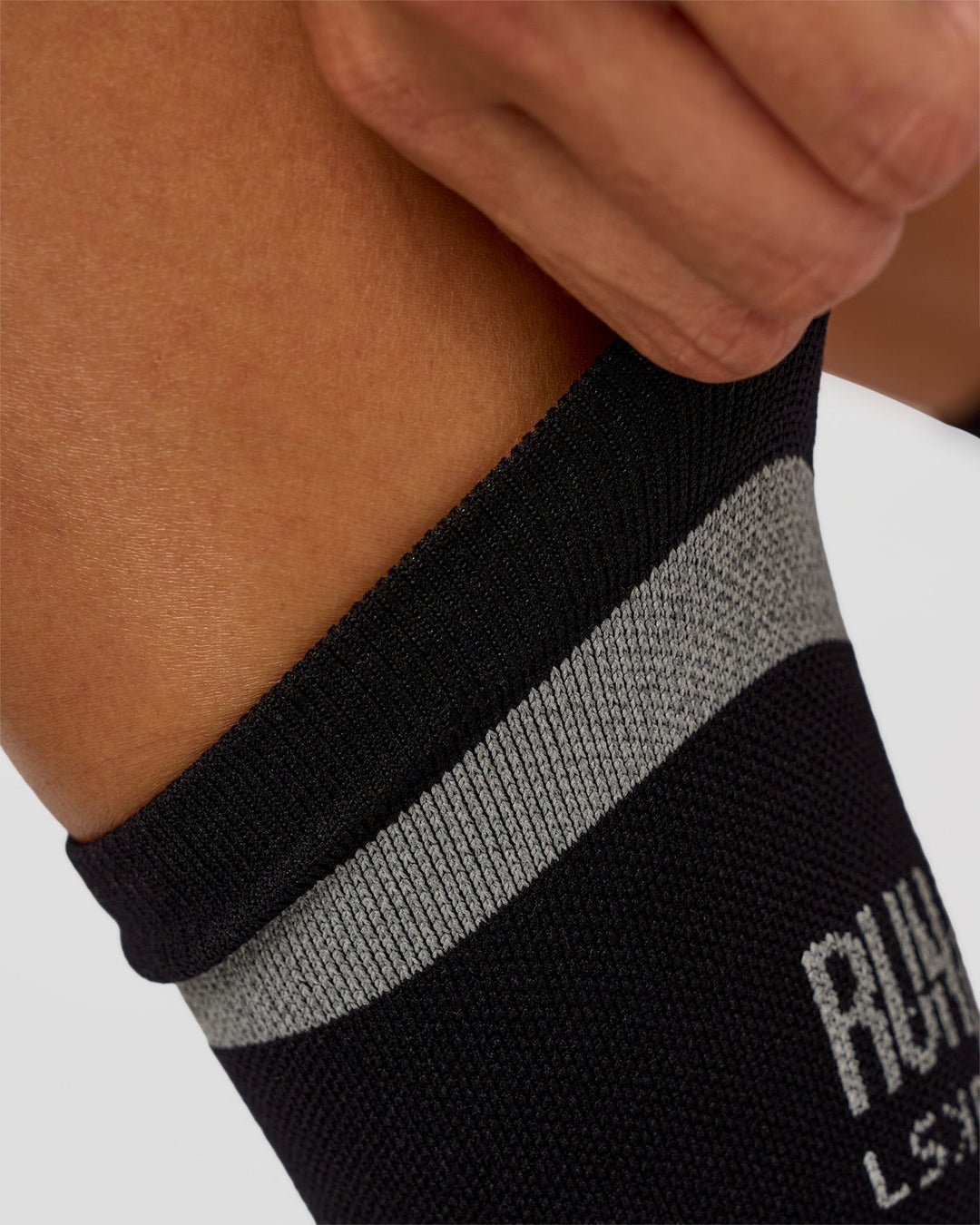 Woman wearing Run Club Fast Performance Socks 2.0 - Black-Reflective - view 5